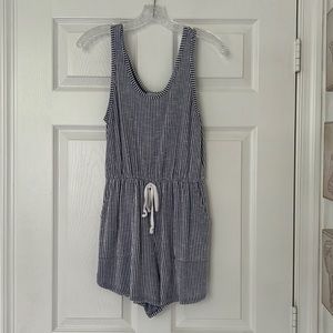 White and blue stripped romper with two front deep pockets.